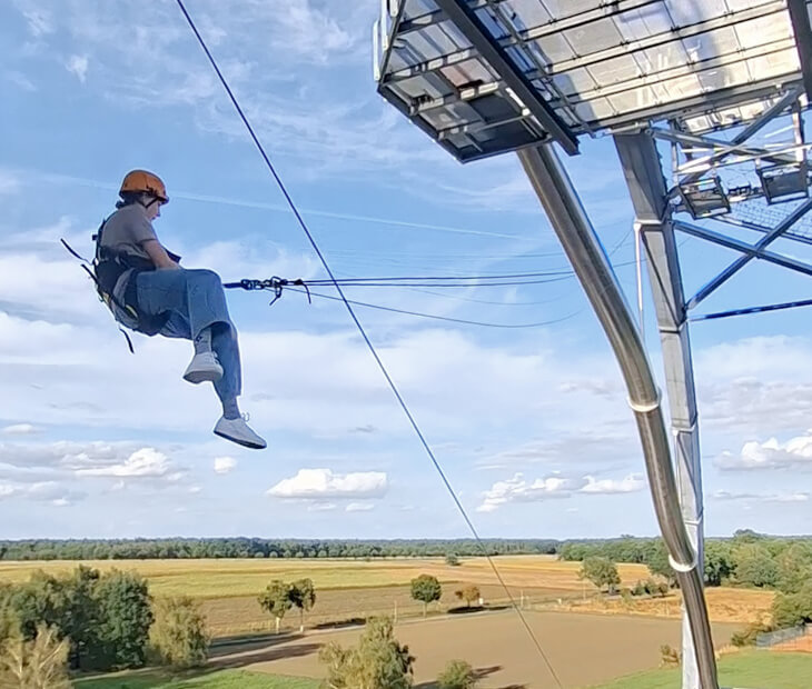 Einer Person bleibt beim Schaukelt mit der Riesenschaukel Giantswing der Schrei im Hals stecken
